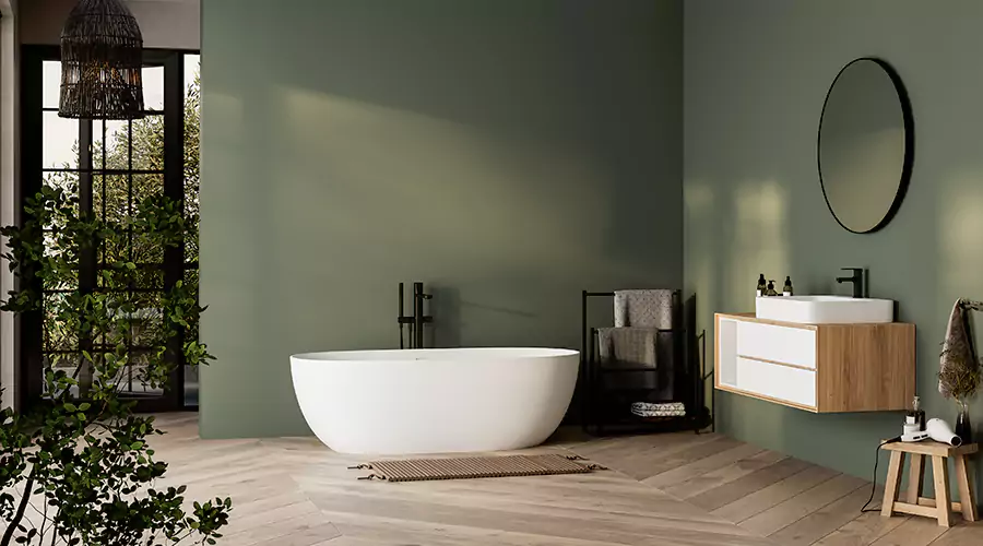 Stylish bathroom with green walls, freestanding tub, and minimalist vanity